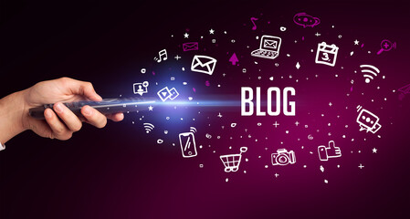 hand holding wireless peripheral with BLOG inscription, social media concept