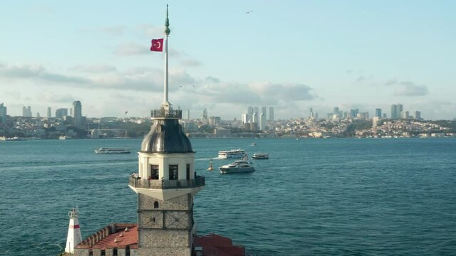 Maiden's Tower Establishing Shot in the middle of the Bosphorus Water in Istanbul with Turkey Flag waving on top