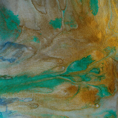 Abstract watercolor flow blot painting. Color green and gold marble texture background