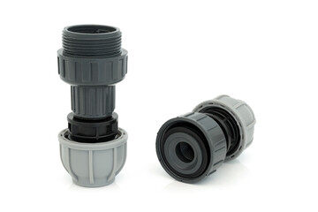 Plastic MDPE non return value plumbing compression fitting used to facilitate the flow of liquid in one direction only, on white background.