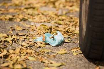 Waste during COVID-19. Discarded to single-use coronavirus face masks. Pollution of the environment, in the city