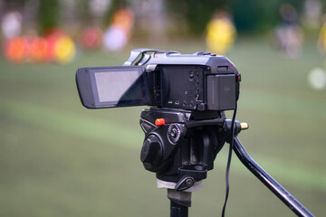 Camcorder on a tripod. Shooting outdoors.