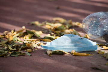 Waste during COVID-19. Discarded to single-use coronavirus face masks. Pollution of the environment, in the city