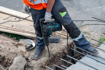 worker with a jackhammer during roadworks