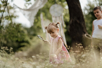 Toddler is playing with a magnifying glass and exploring