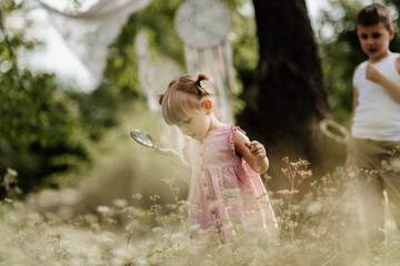 Toddler is playing with a magnifying glass and exploring