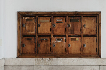 Vintage wooden mail boxes in a row in residential building in Florence