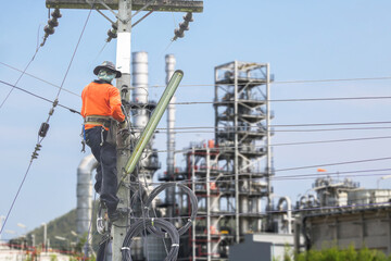 Working at height on oil refinery plant background