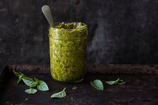 Herb pesto sauce in a glass storage jar