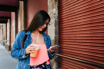Beautiful hispanic woman scrolling on her phone