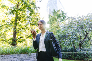 Indian businesswoman using cellphone in the city