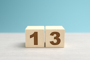 Wooden toy blocks forming the number 13.