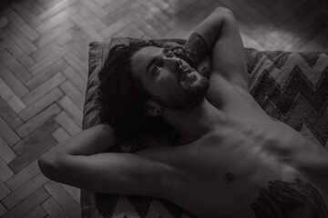 Black and white portrait of a guy at bed