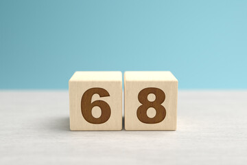 Wooden toy blocks forming the number 68.