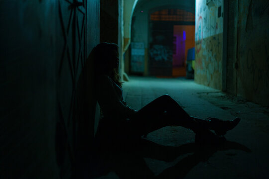 silhouette of a sitting girl on the floor