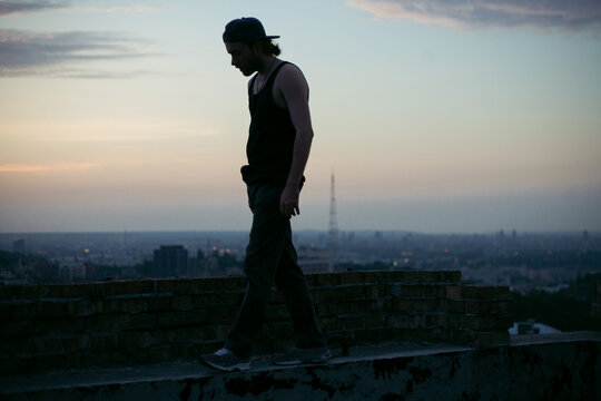 silhouette of a guy against the background of the night city and sky