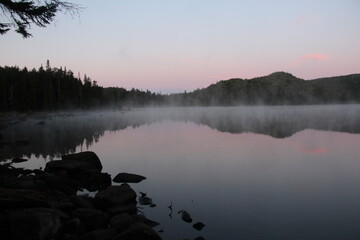 Mist rising from the warm lake at dawn