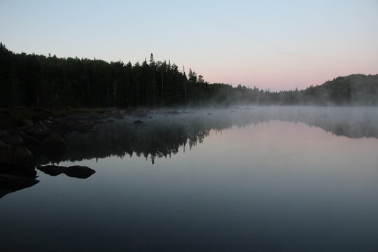 Mist rising from the warm lake at dawn