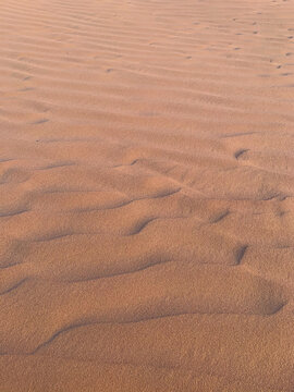 Abstract texture of boundless sand yellow dunes stretching into distance