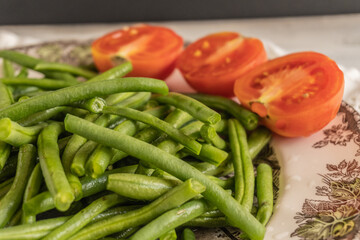 Fresh green beans ready to cook on a wooden table. Copy space