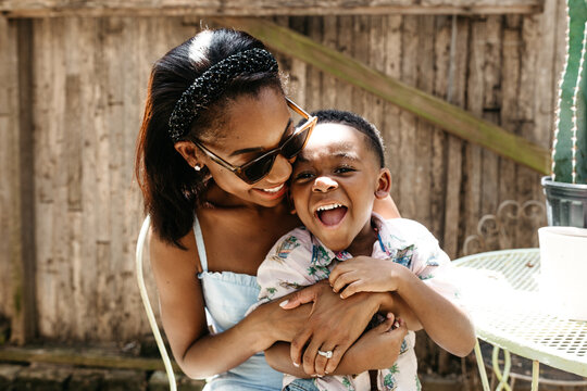A mother hugging her son.