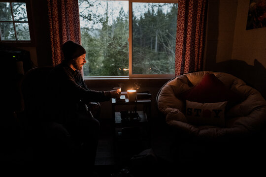 Man Drinking Coffee In Cabin