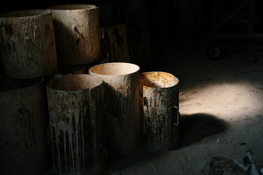 Metal rusty barrels in a foundry
