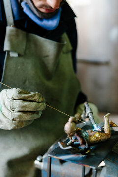 Man using a blowtorch in a foundry