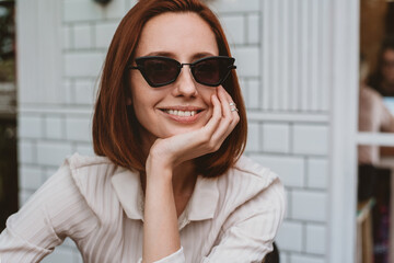 Portrait of a attractive woman wearing trendy sunglasses