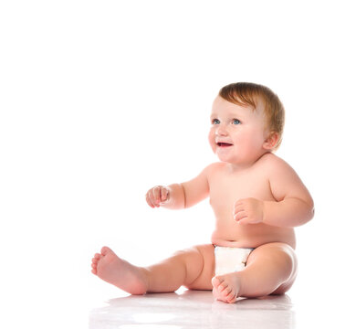 Cute laughing baby child in diaper studio portrait
