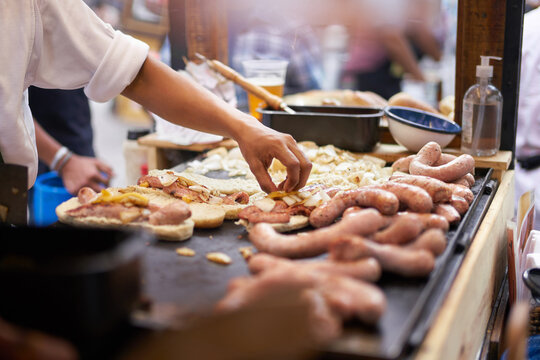 Cook preparing takeaway sandwich at street food stall