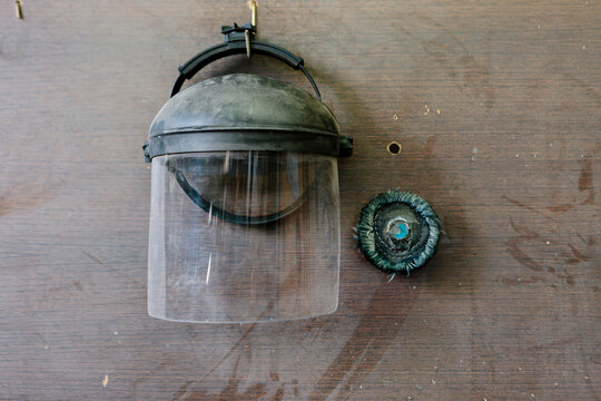 Protective helmet hanging on a wood wall