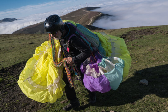 Man carrying paraglider