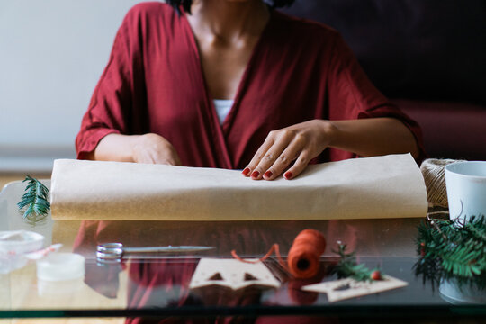 Woman wrapping Christmas gifts indoor