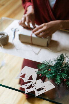 Woman wrapping Christmas gifts indoor