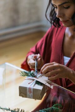 Woman wrapping Christmas gifts indoor