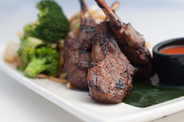 Lamb chops with vegetables in white background
