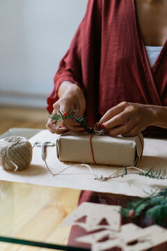 Woman wrapping Christmas gifts indoor