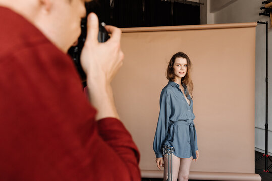 Anonymous photographer taking pictures of model with fractured leg