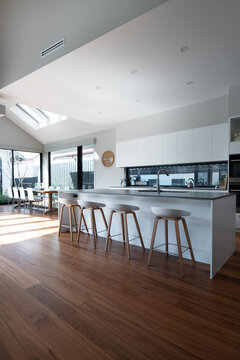 Contemporary kitchen with white bar stools