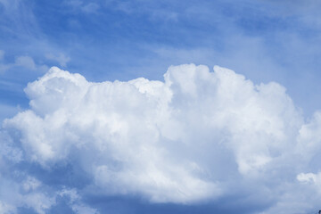 Blue sky with dramatic cumulus clouds.