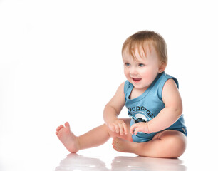 Close up of a cute happy baby boy playing on a white background.