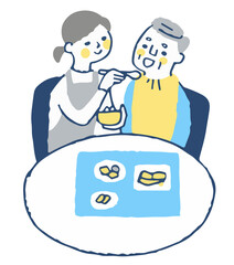 食事の介助をする女性とシニア男性