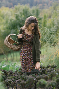 Gardener With Basket Walking Through Field