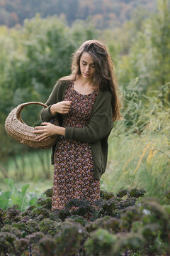 Gardener With Basket Walking Through Field