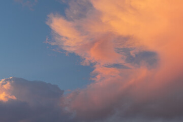 Colorful clouds at sunset in blue sky.