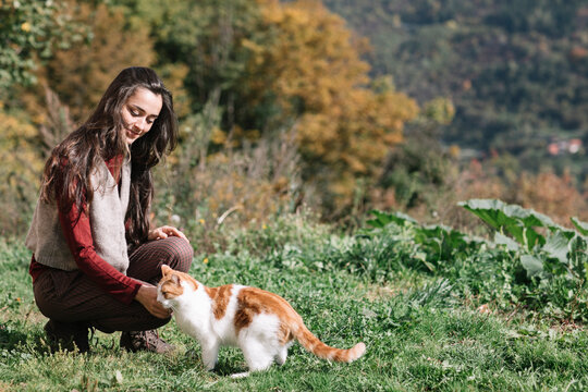 Young Woman Playing A Little Cat