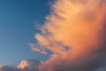 Colorful clouds at sunset in blue sky.