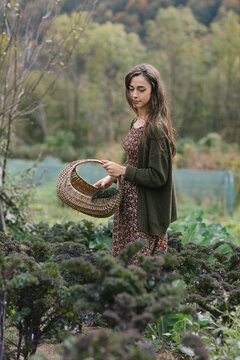 Gardener With Basket Walking Through Field