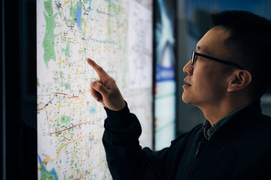 Businessman looking at the map at subway station